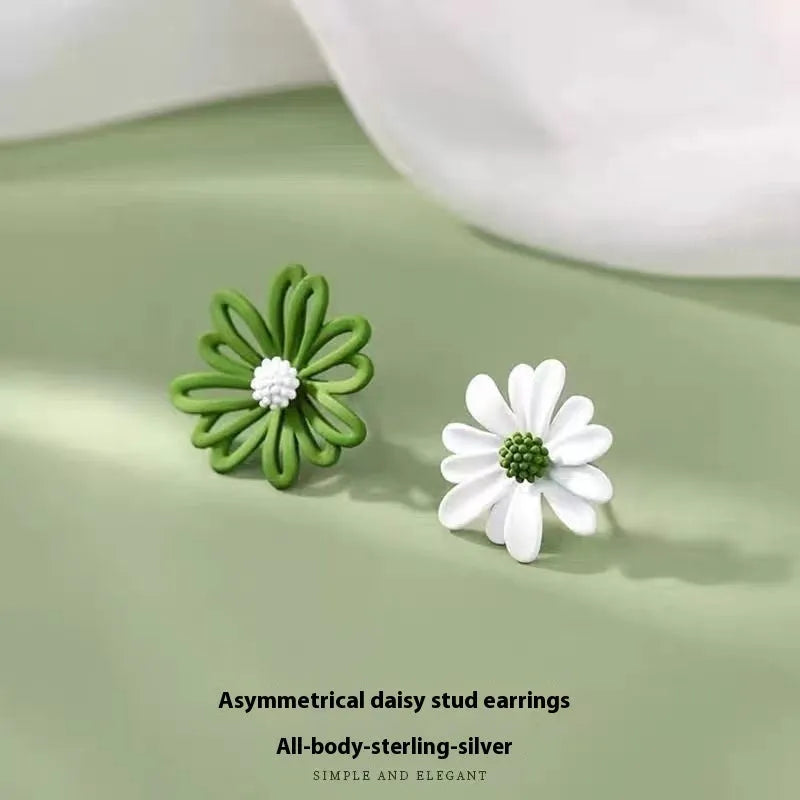 A pair of cartoon-style flower stud earrings in alloy, shown in a two-tone colour option.