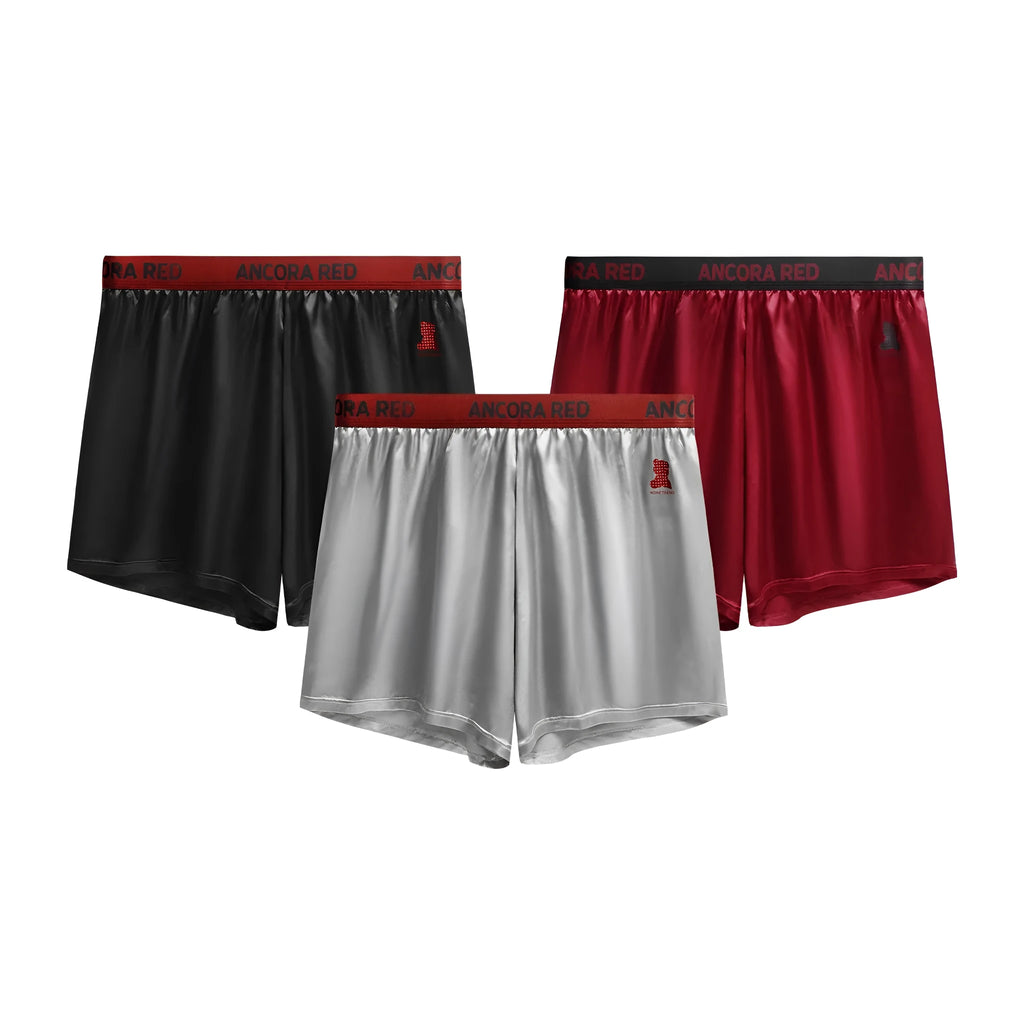 Men's solid colour boxer briefs in black, red, blue, silver, purple, and brown on a mid-waist fit.