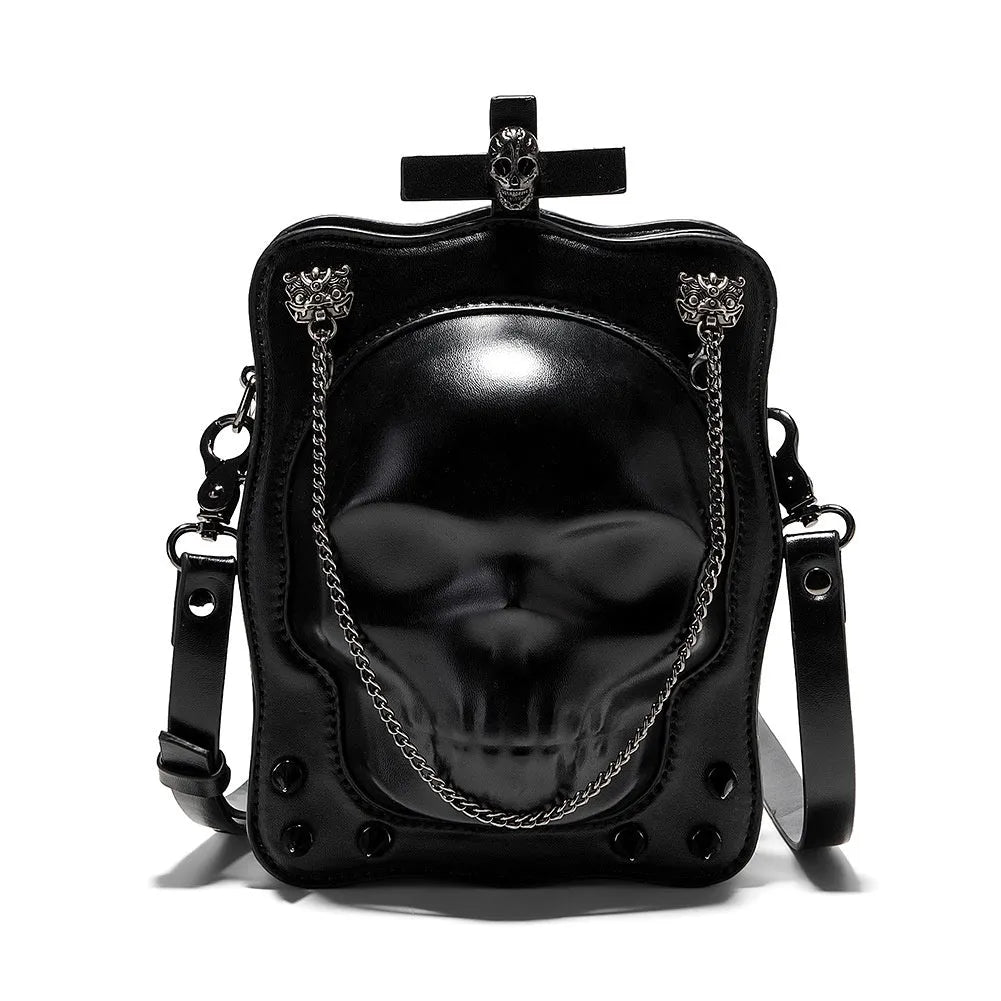 Black mini square crossbody bag with embossed skull design, decorative stitching, rivets, and chain details.