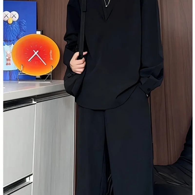 Men's black slim fit two-piece casual suit with long sleeve polo shirt and trousers on a hanger.