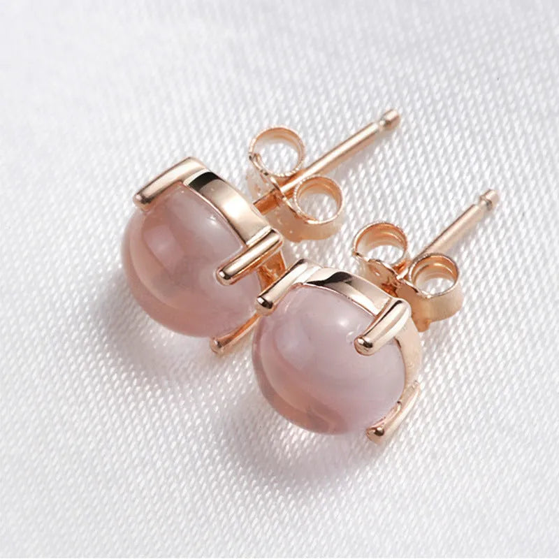 Rose gold coloured drop shape stud earrings with crystal inlay on silver base.