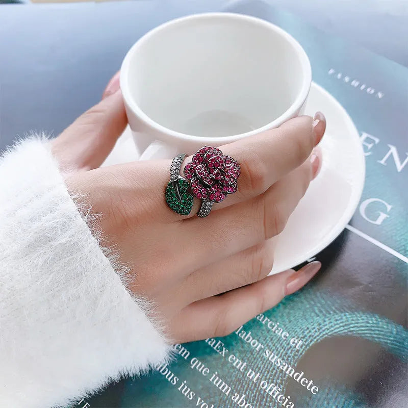 Gold-plated black gold ring with simulation red corundum stone and geometric flower design