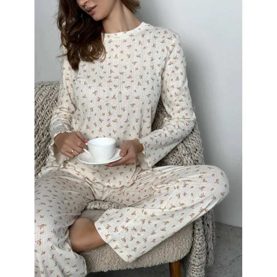 White women's floral print bell sleeve top and wide leg pants casual suit set laid flat