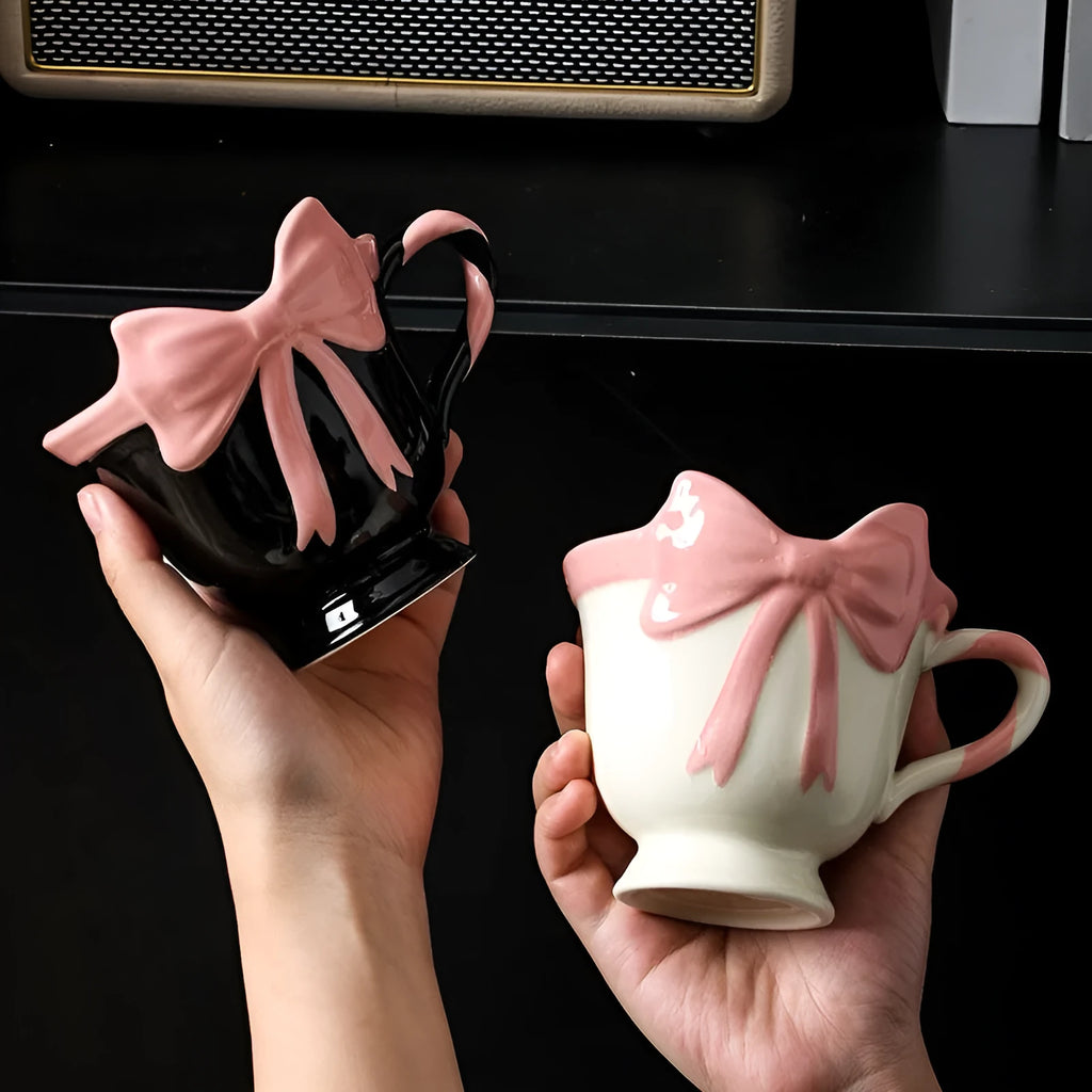Ceramic mug with heart bow design in cute style showing Black Pink and White Powder colour options
