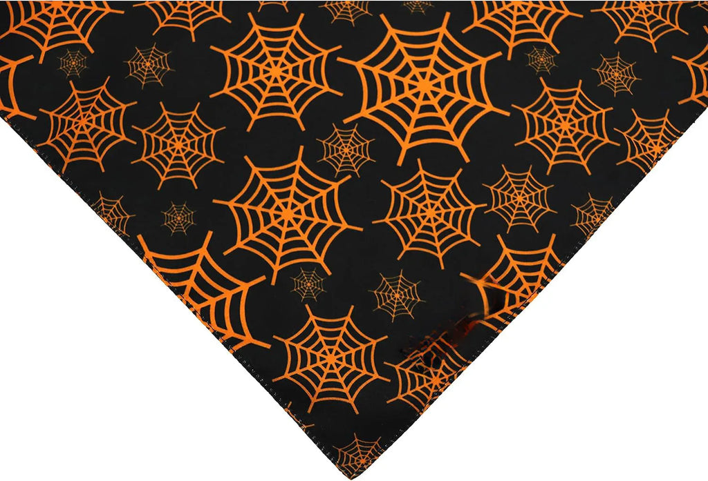 Reversible Halloween dog bandana showing pumpkin and spider web patterns in black and orange colours
