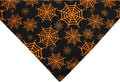 Reversible Halloween dog bandana showing pumpkin and spider web patterns in black and orange colours