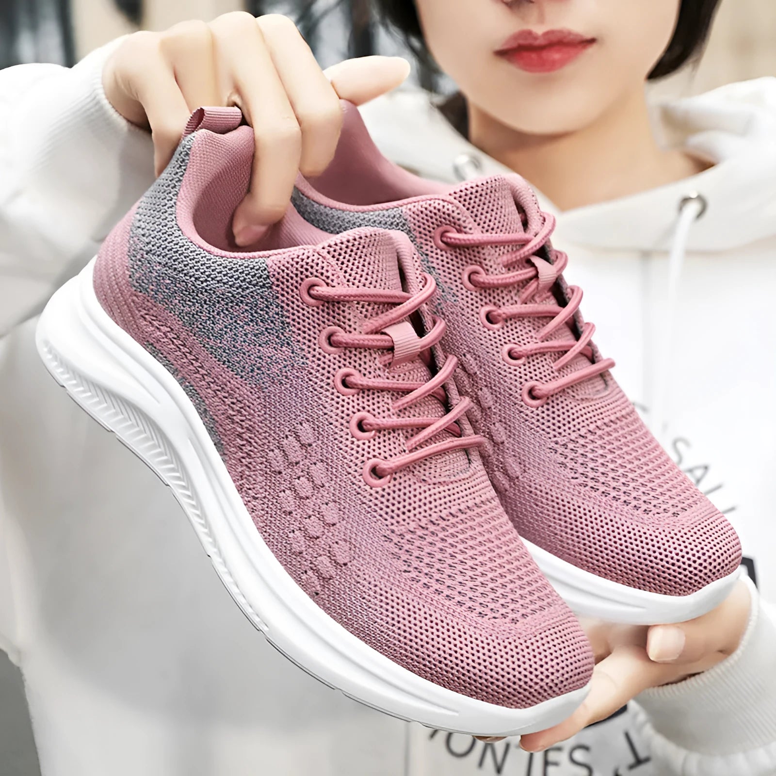 Women's low-top black mesh sneakers with round toe and white PVC sole, shown with lace-up front.