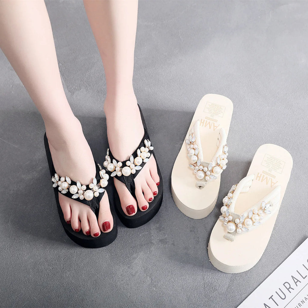 Women's beige high-heeled flip-flops with a cotton cloth upper on a white background.