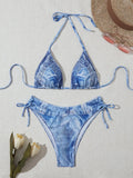 Women's denim blue printed bikini swimsuit with strap design on a hanger