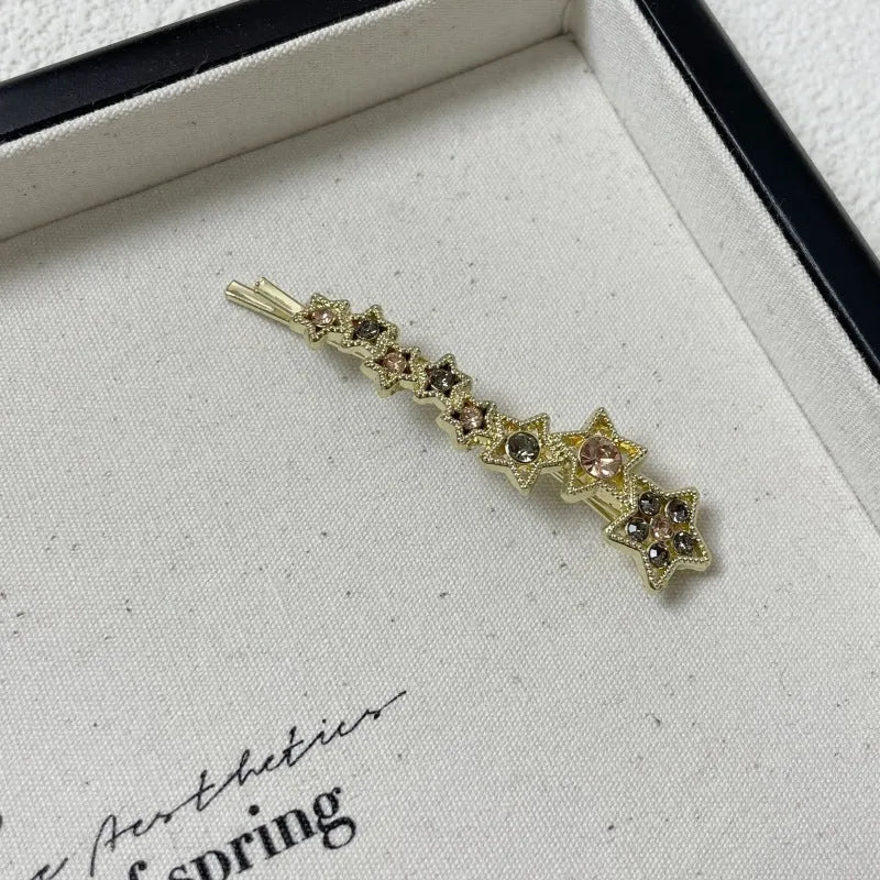 Gold rhinestone barrette with star design for clipping bangs and side hair