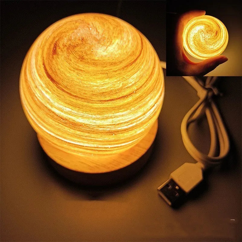 Compact modern planet USB night light on its base with dimmable three-colour lighting.