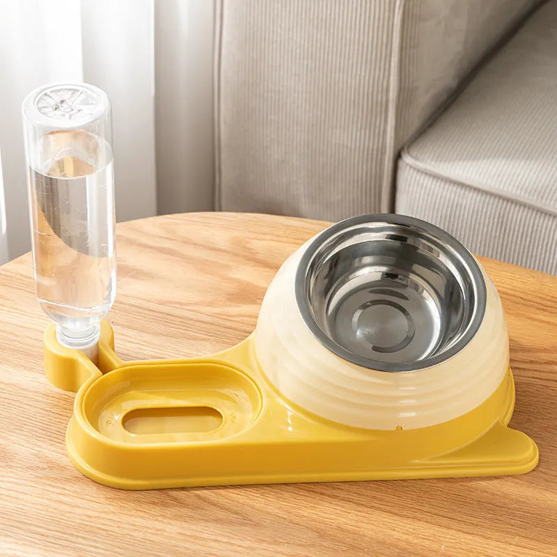 Brown elevated cat bowl with attached water dispenser bottle on a wooden floor.