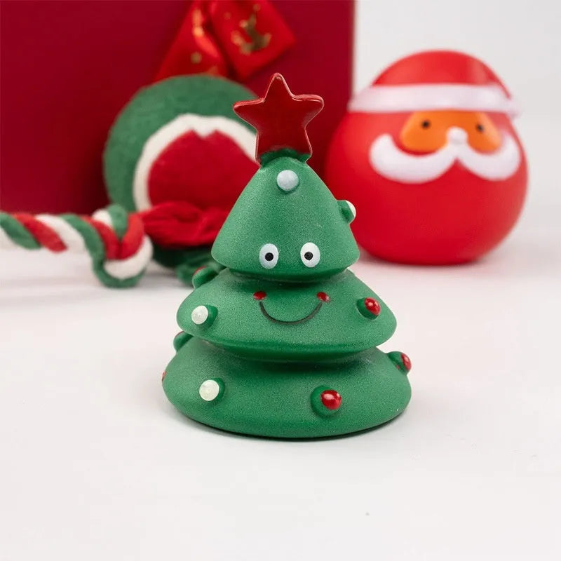 Christmas-themed vinyl dog chew toy set including barbells, balls, ropes, and festive figures in gift packaging.