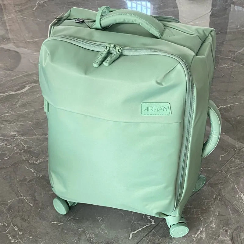 Ultra-light waterproof Oxford cloth suitcase with universal wheels in a bluestone green colour.