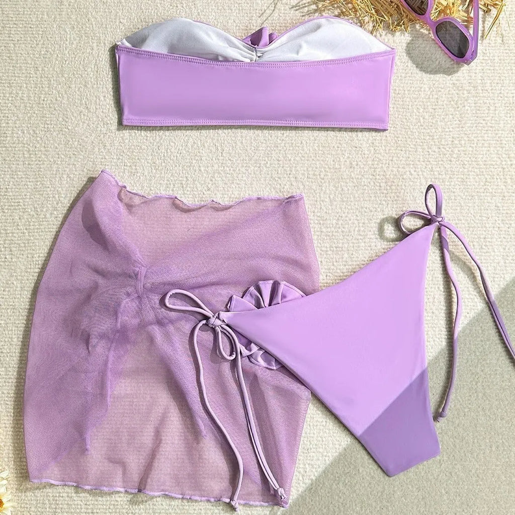 Women's pink swimsuit set with floral tube top, pants, and skirt for swimming.