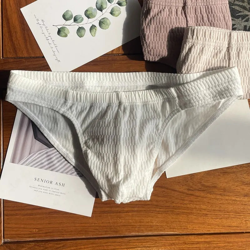 Men's solid colour cotton triangle briefs with a mid-waist waistband on a white background.