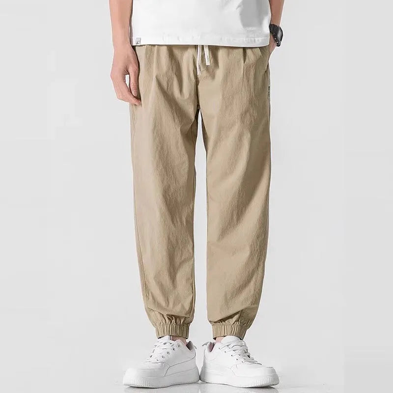 Men's fashion loose cuffed cargo pants in black, made from polyester, available in sizes S to 3XL.