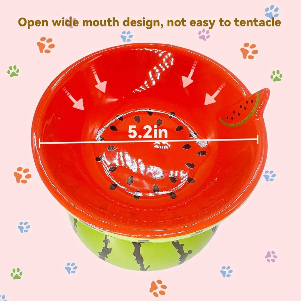 Ceramic elevated cat bowl with tilted surface in a colourful fruit pattern, showing its height and wide design.