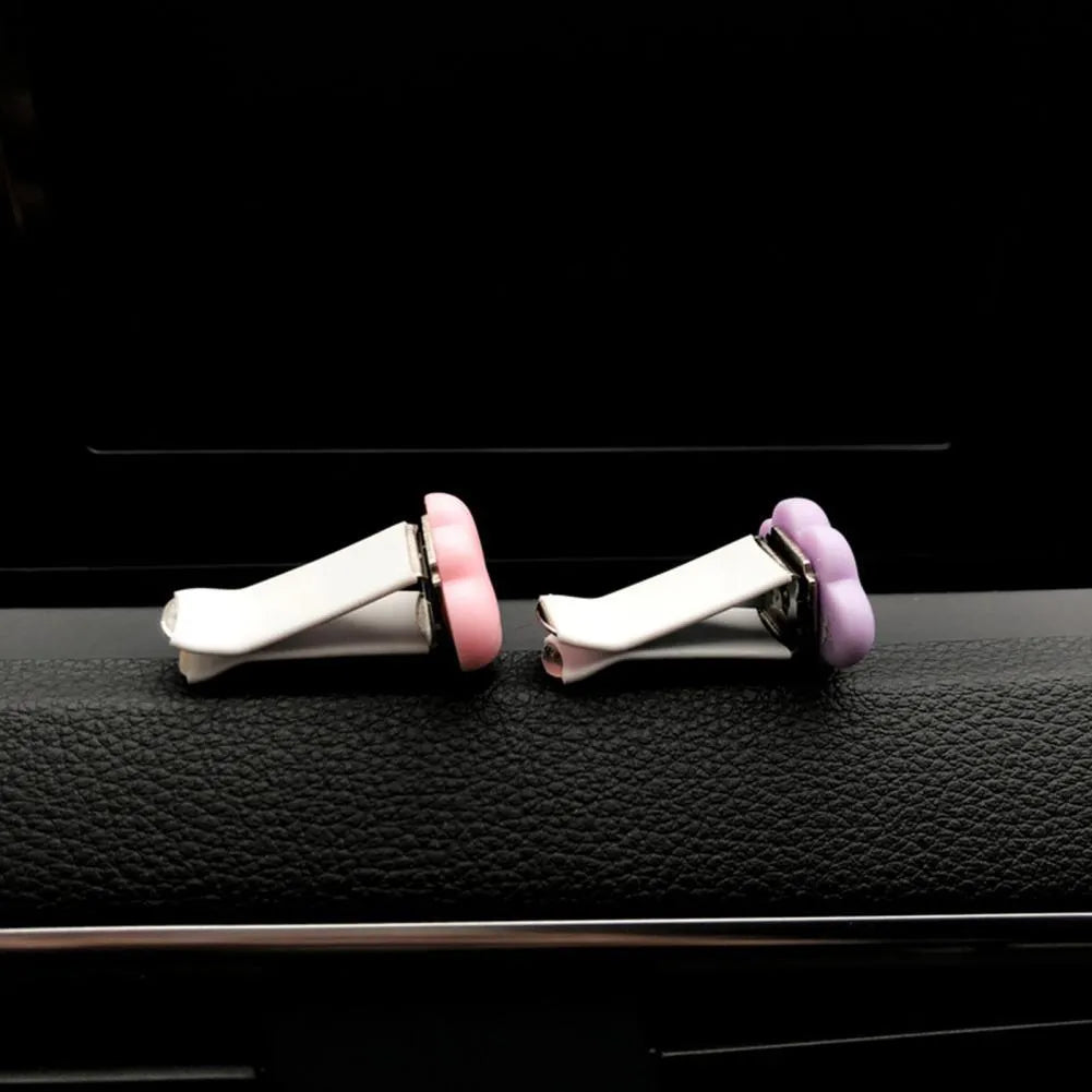 Baiyun cartoon car fragrance clip in resin, shown in various colours for air vent mounting.