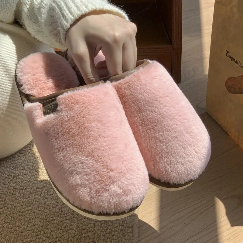 Solid colour PVC plush slippers with non-slip sole and car stitching detail on a wooden floor.