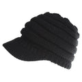 Woman wearing a soft knitted beanie with a ponytail pulled through the hole at the back.