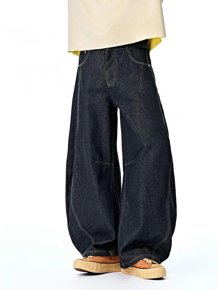 Men's original cow coloured wide leg denim trousers with a mid waist, laid flat.