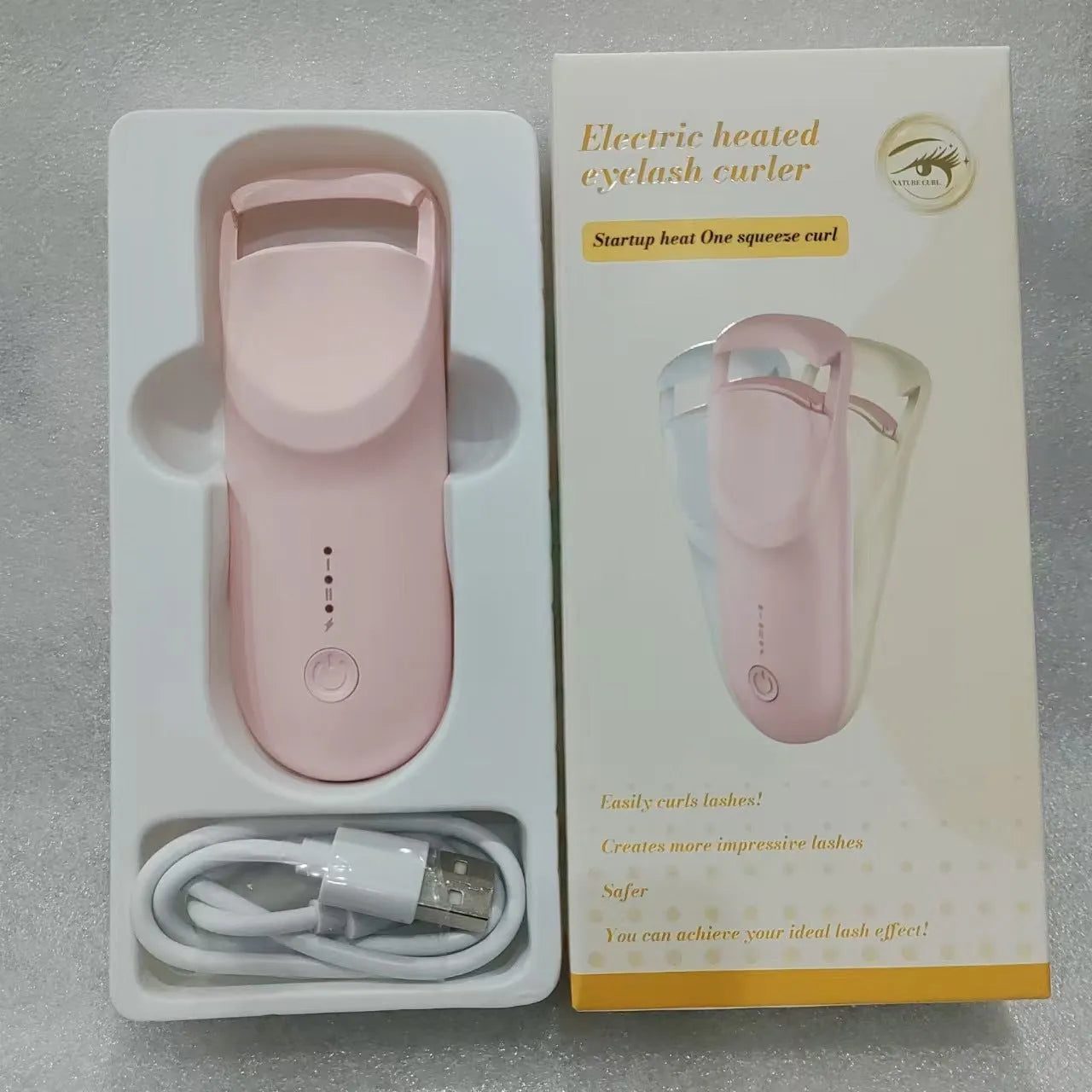 USB-rechargeable electric heating eyelash curler in cream white colour with cable