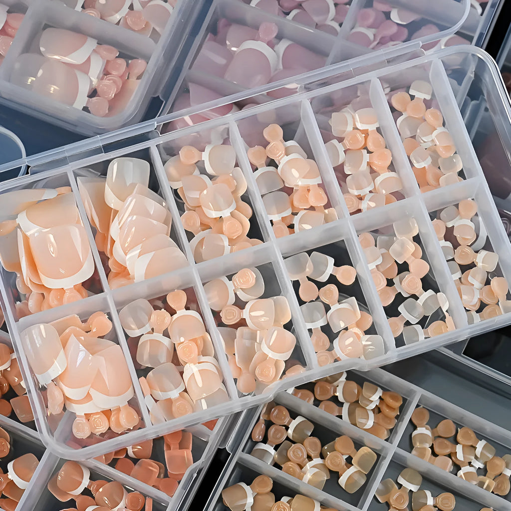 120-piece box of French white tip false toenails in nude colours, square short shape.