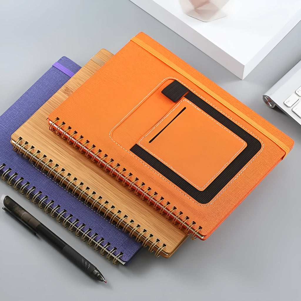 A5 spiral bound reusable notebook with stone paper, shown with pen on customisable coloured cover.