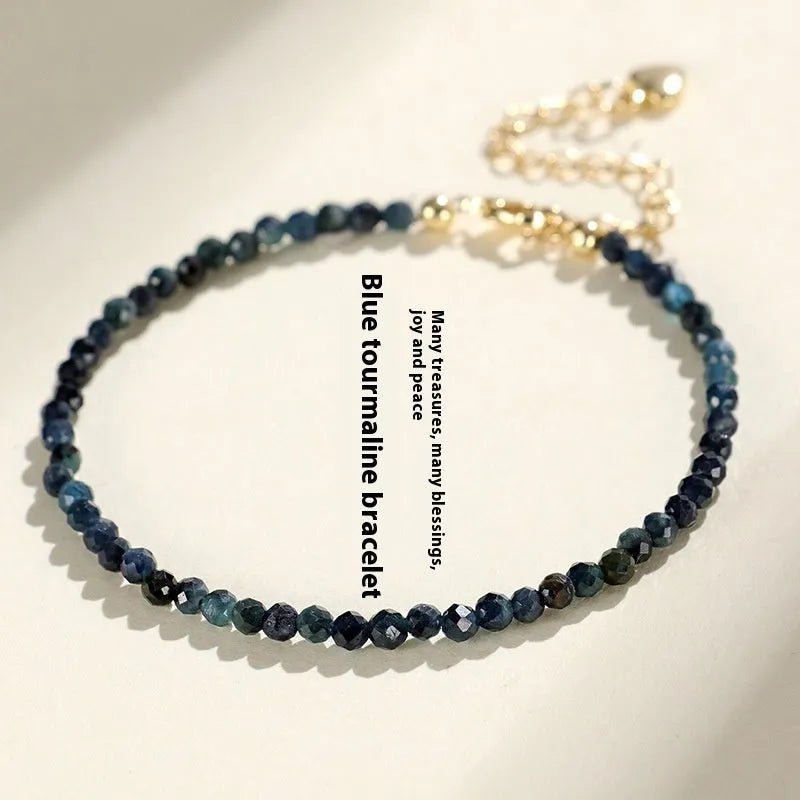 Blue tourmaline bracelet with 3mm beads and spacer bead design on wrist