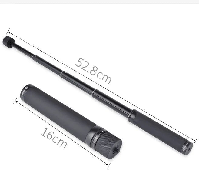 Black aluminium retractable selfie stick extended to full length with phone attached, showing included tripod stand and wireless remote.