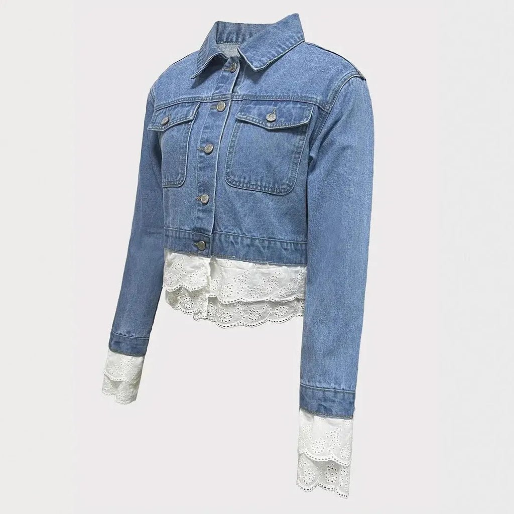 Blue women's denim jacket with lace stitching detail on the front.