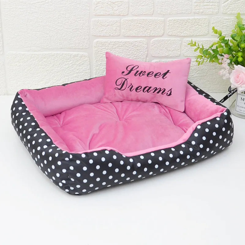 Polka dot print square dog bed with raised sides and a matching embroidered pillow in grey.