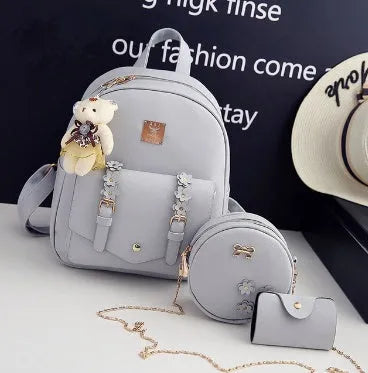 Women's floral pu leather three-piece bag set showing backpack, shoulder bag, and card purse.