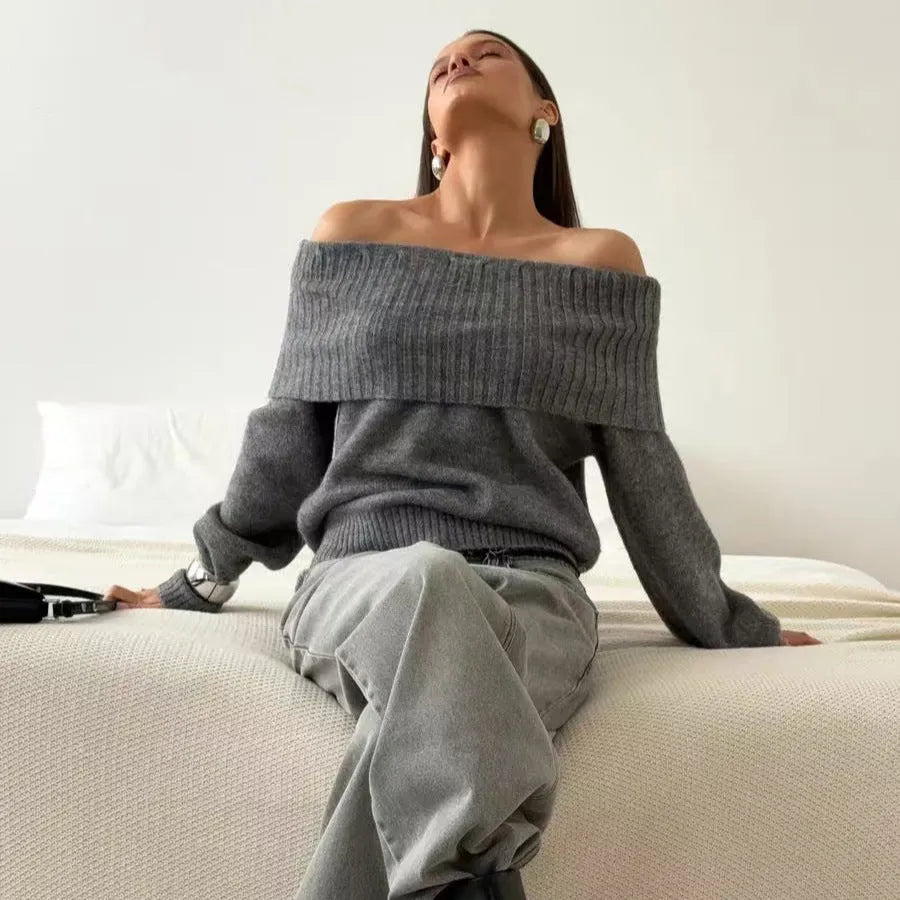 Woman wearing a grey off-the-shoulder strapless sweater with a 3D textured pattern.