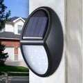 Black solar-powered LED wall light with solar panel and automatic activation