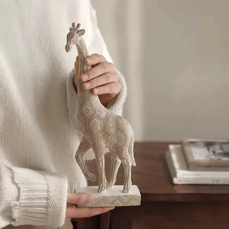 30.5cm tall synthetic resin giraffe ornament in wood colour standing on a shelf