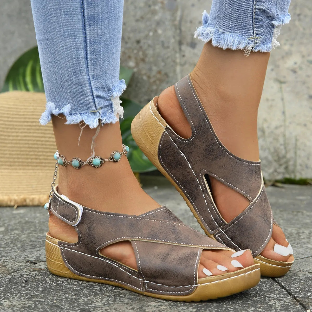 Women's brown platform Roman sandals with skirted ankle strap and Velcro fastening on a white background.