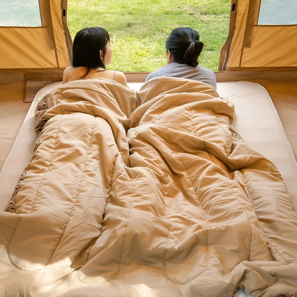 Four seasons camping sleeping bag in swamp colour, shown with its storage bag.