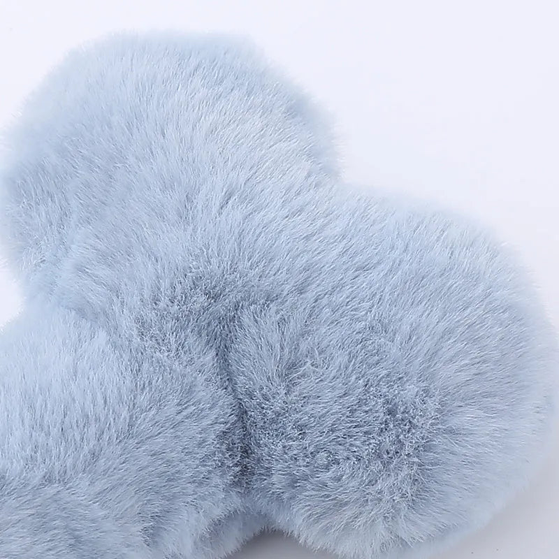 Blue plush love bone dog toy with a squeaker, shown next to pink and yellow versions.