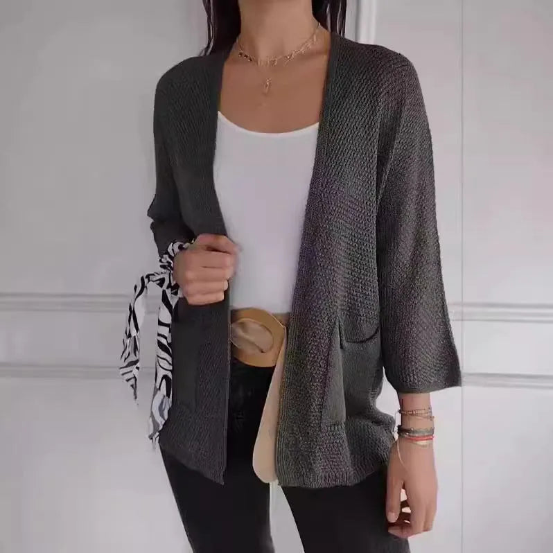 Women's thin waffle weave cardigan coat in army green with pockets, shown on a hanger.