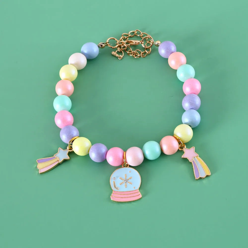 Macaron-coloured resin pet collar and bracelet set for birthday photoshoots on a neutral background.