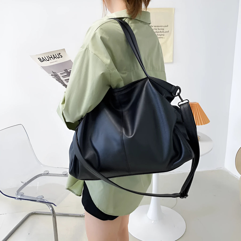 Soft surface messenger bag with adjustable strap showing mobile phone pocket and zipper compartments