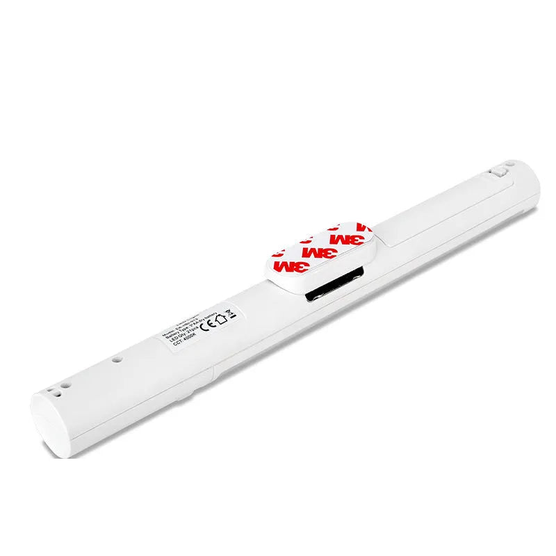 Slim white human body induction LED cabinet light with magnetic strip on back for mounting