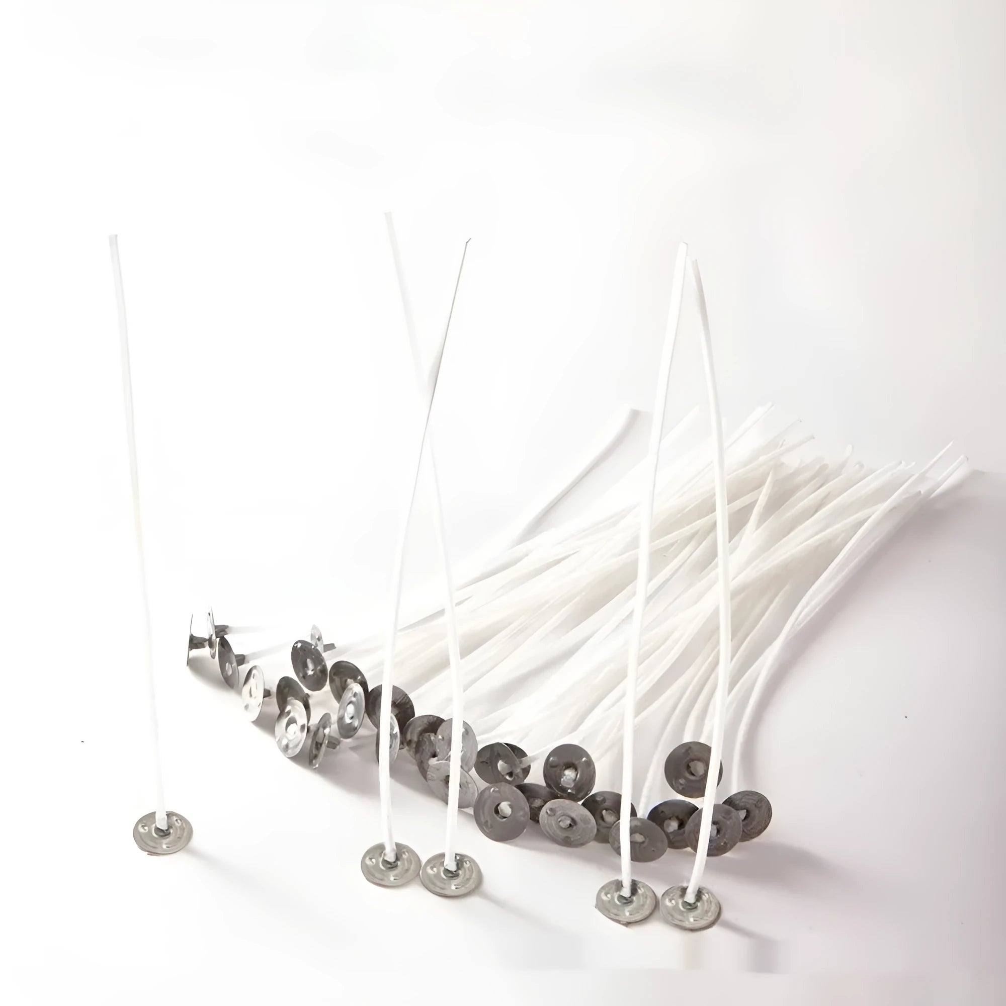 White cotton candle wicks in three lengths - 2.6cm, 6cm, and 8cm - for DIY candle making projects