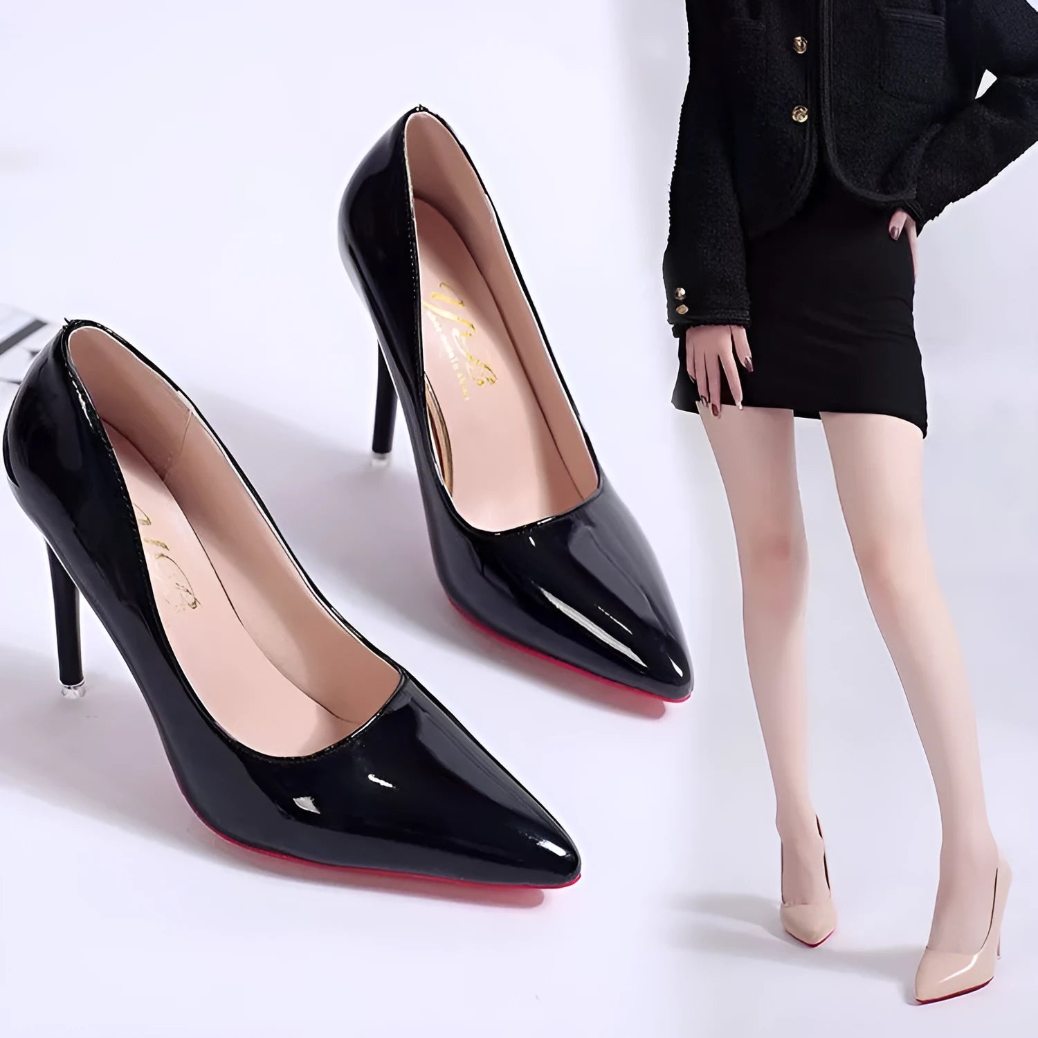 Women's black pointed toe stiletto heel pumps with a shallow mouth design on a plain background.