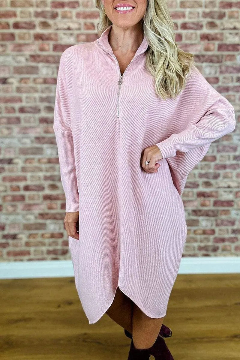 Women's solid colour loose fit knit dress with raglan sleeves on a hanger.