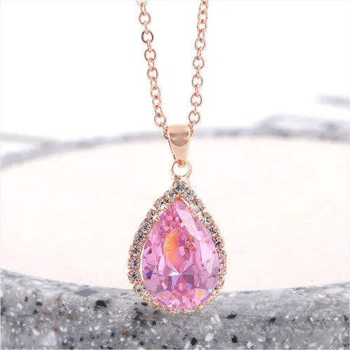 Rose gold plated drop pendant necklace with colourful rhinestones in a pink colour option.