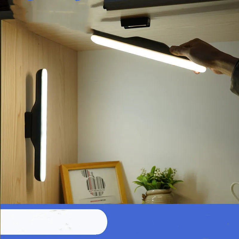 Modern minimalist white plastic LED desk lamp with a touch-sensitive base on a wooden desk.