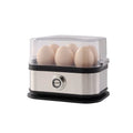 Small black stainless steel portable egg boiler with plug adapters on a countertop.